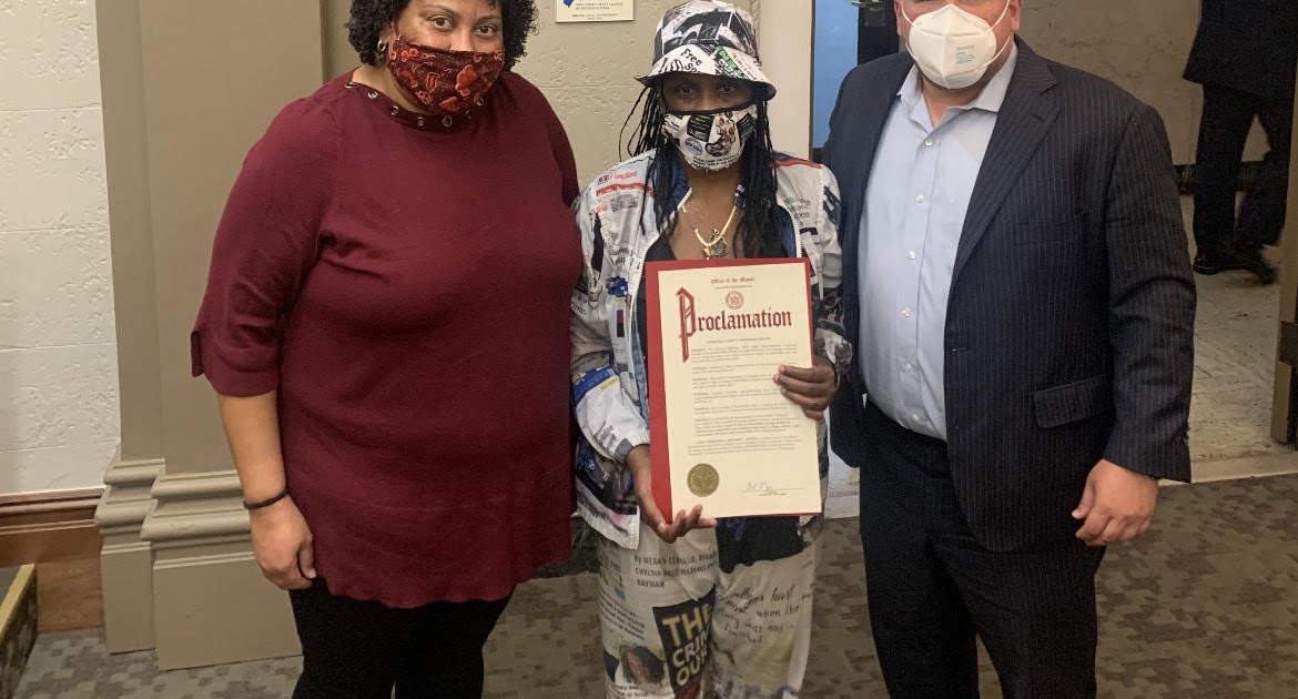 Deshon Johnson's Mother  Holding Her Son's Proclamation with Bloomfield Council Women Sarah Cruz  and Mayor  Raymond McCarthy