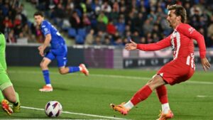 five star atletico madrid forward antoine griezmann netted a hat trick as his side thrashed getafe to secure champions league football photo afp