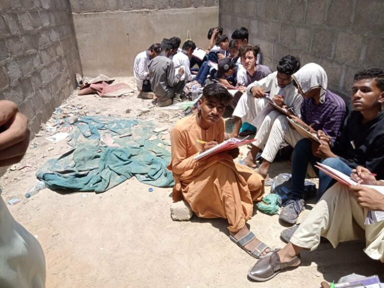 Students solve papers under scorching sun