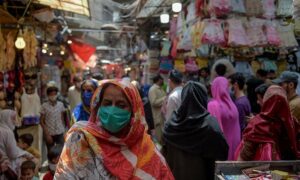 Women shop at a market after the government eased the lockdown imposed as a preventive measure against the COVID-19 coronavirus, in Rawalpindi on May 9, 2020. (Photo by Farooq NAEEM / AFP)