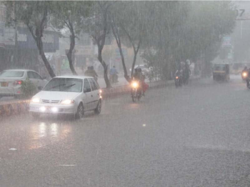 commuters drive through rain on a road photo express file